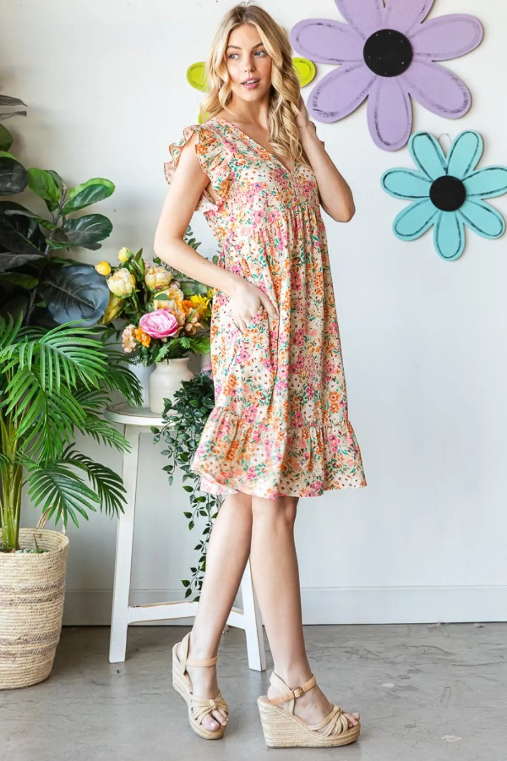 Heimish full size floral ruffled v-neck dress with feminine design, shown on a model with a flowing skirt and floral print.