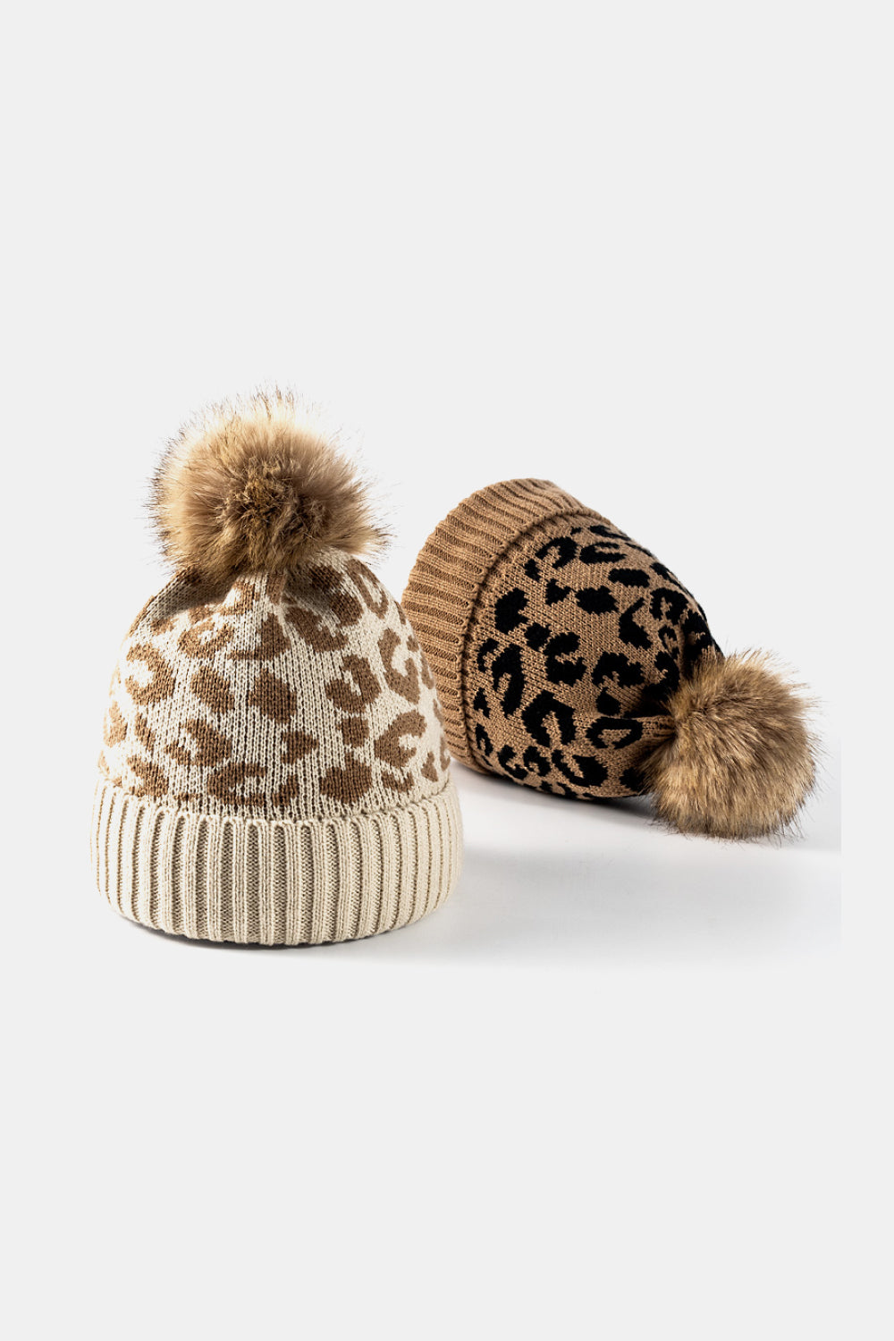 Leopard print pom-pom cuffed beanie by Trendsi featuring a cozy knit design and playful faux fur pom-pom on top.