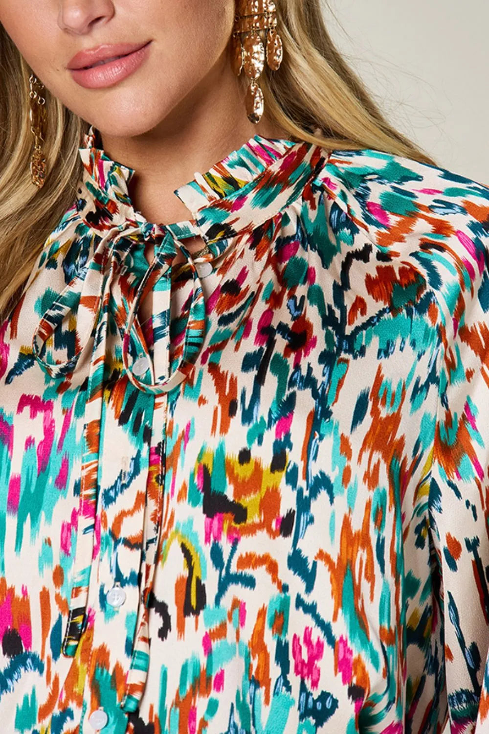 Plus size printed button-up long sleeve shirt from Trendsi, featuring a stylish design and comfortable fit.