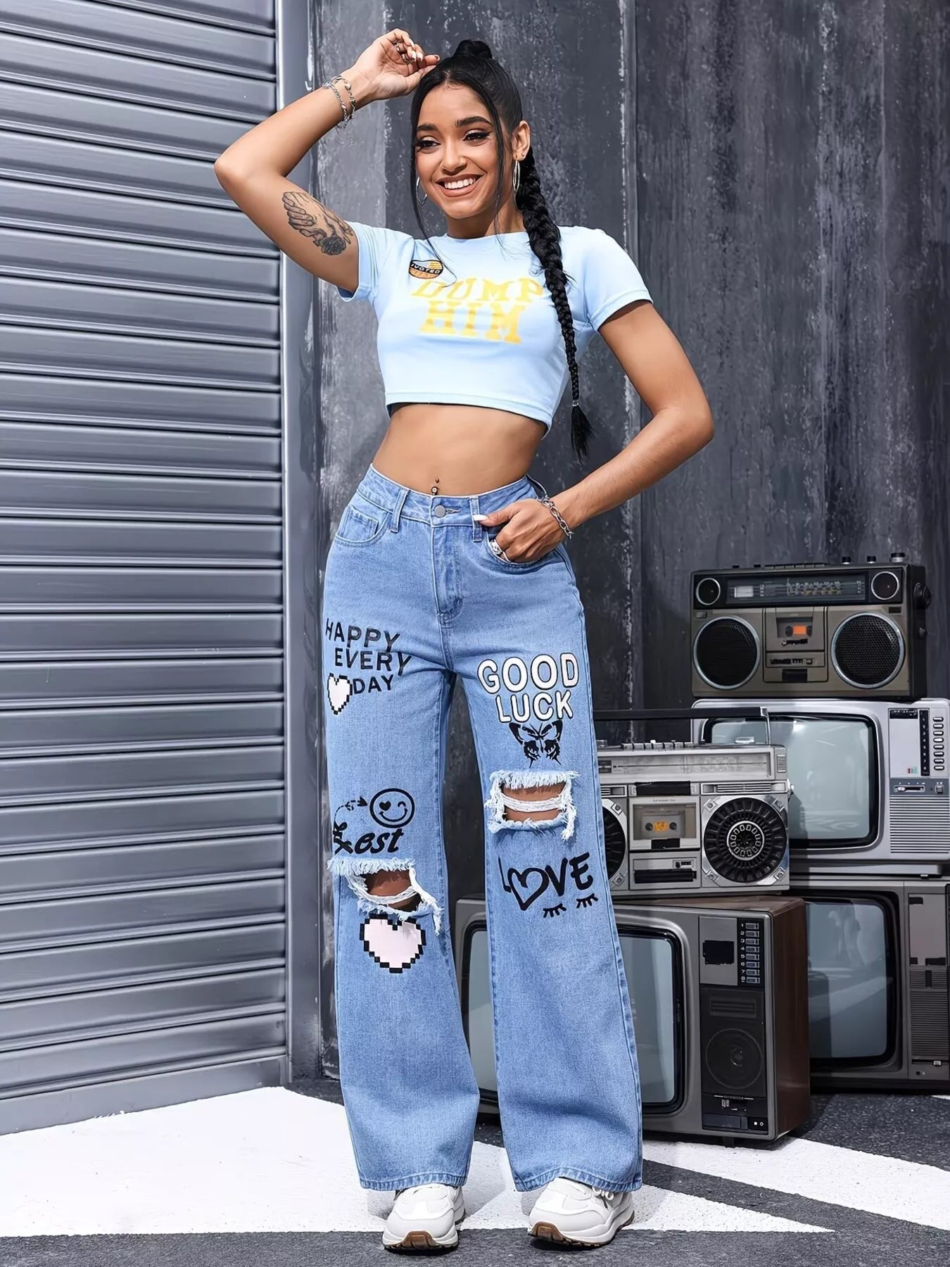 Blue distressed printed wide-leg jeans by Trendsi, showing a relaxed fit with ripped details and bold printed design.