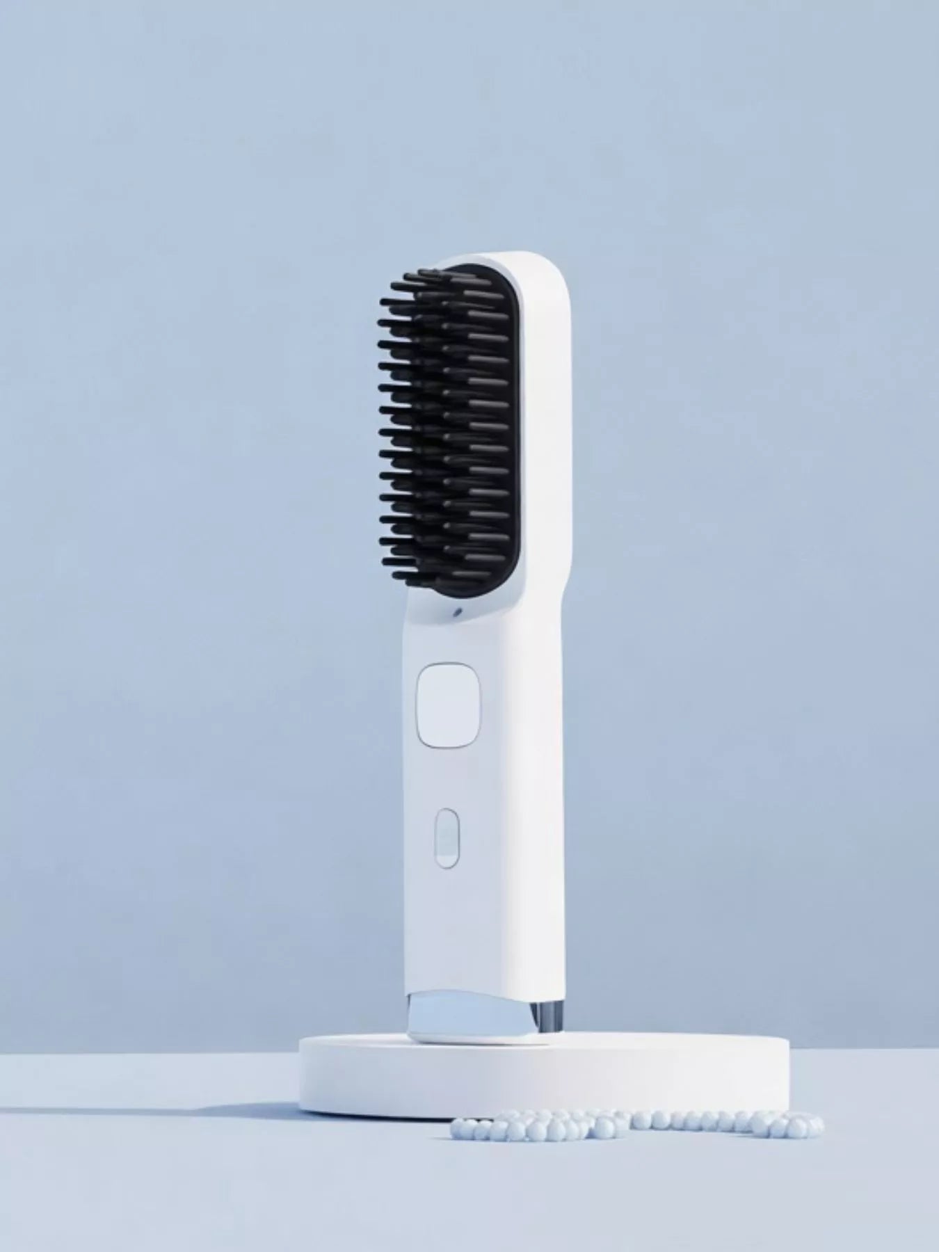Blush pink Trendsi heated straightening comb with wide teeth for smooth, straight hair styling.