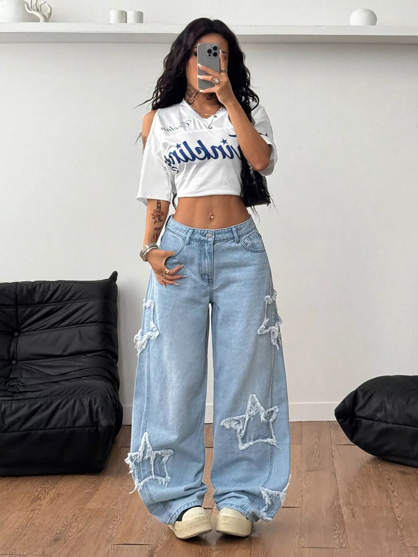 Light blue distressed star patch wide-leg jeans by Trendsi, featuring a relaxed fit and fashionable torn details.