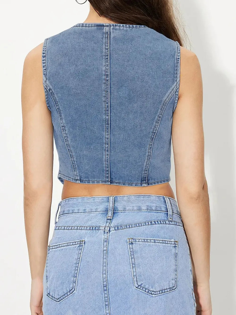 Light blue V-neck button-up denim vest from Trendsi, featuring front buttons and sleeveless design.