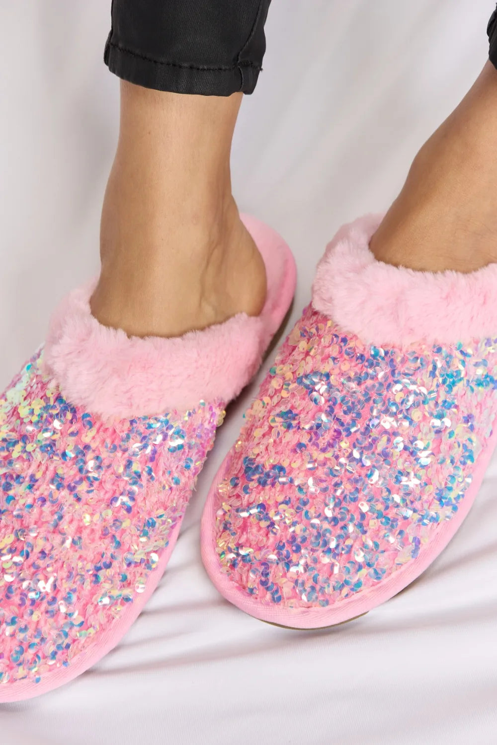 Pink Forever Link Sequin Plush round toe slippers from Trendsi, featuring soft plush material and sparkly sequin details.