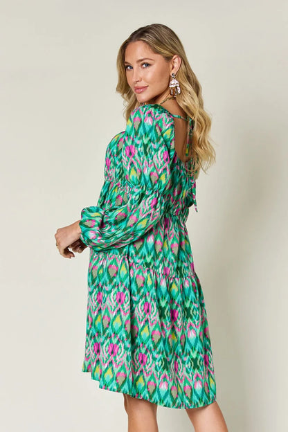 Long sleeve printed dress from the Double Take Full Size collection by Trendsi, showcasing a vibrant pattern and comfortable fit.