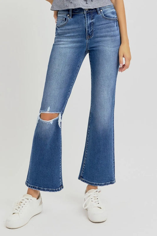 Risen full size distressed high-rise crop flare jeans, blue denim with ripped details and a fitted waist, trendy and stylish.
