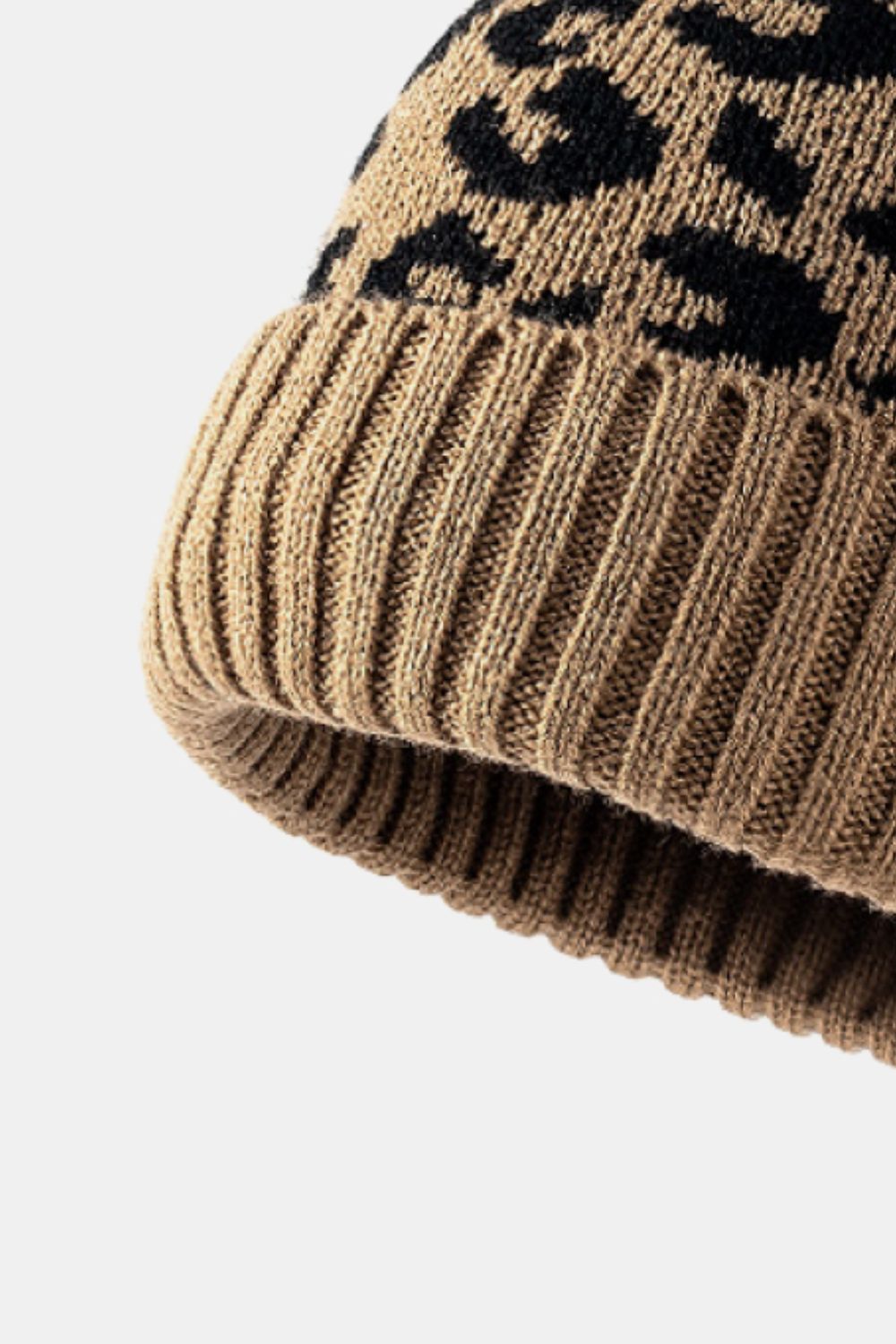 Leopard print pom-pom cuffed beanie by Trendsi featuring cozy knit fabric and a playful faux fur pom-pom on top.