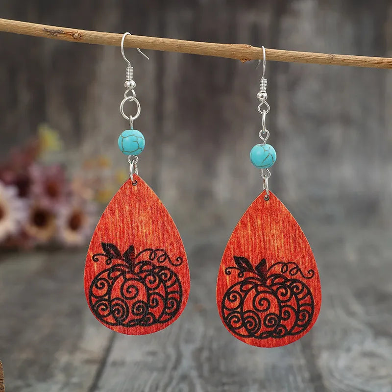 Turquoise wooden pumpkin teardrop earrings with carved details, trendy jewelry accessory perfect for fall or casual wear