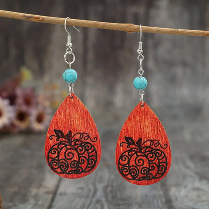 Turquoise wooden pumpkin teardrop earrings with carved details, trendy jewelry accessory perfect for fall or casual wear