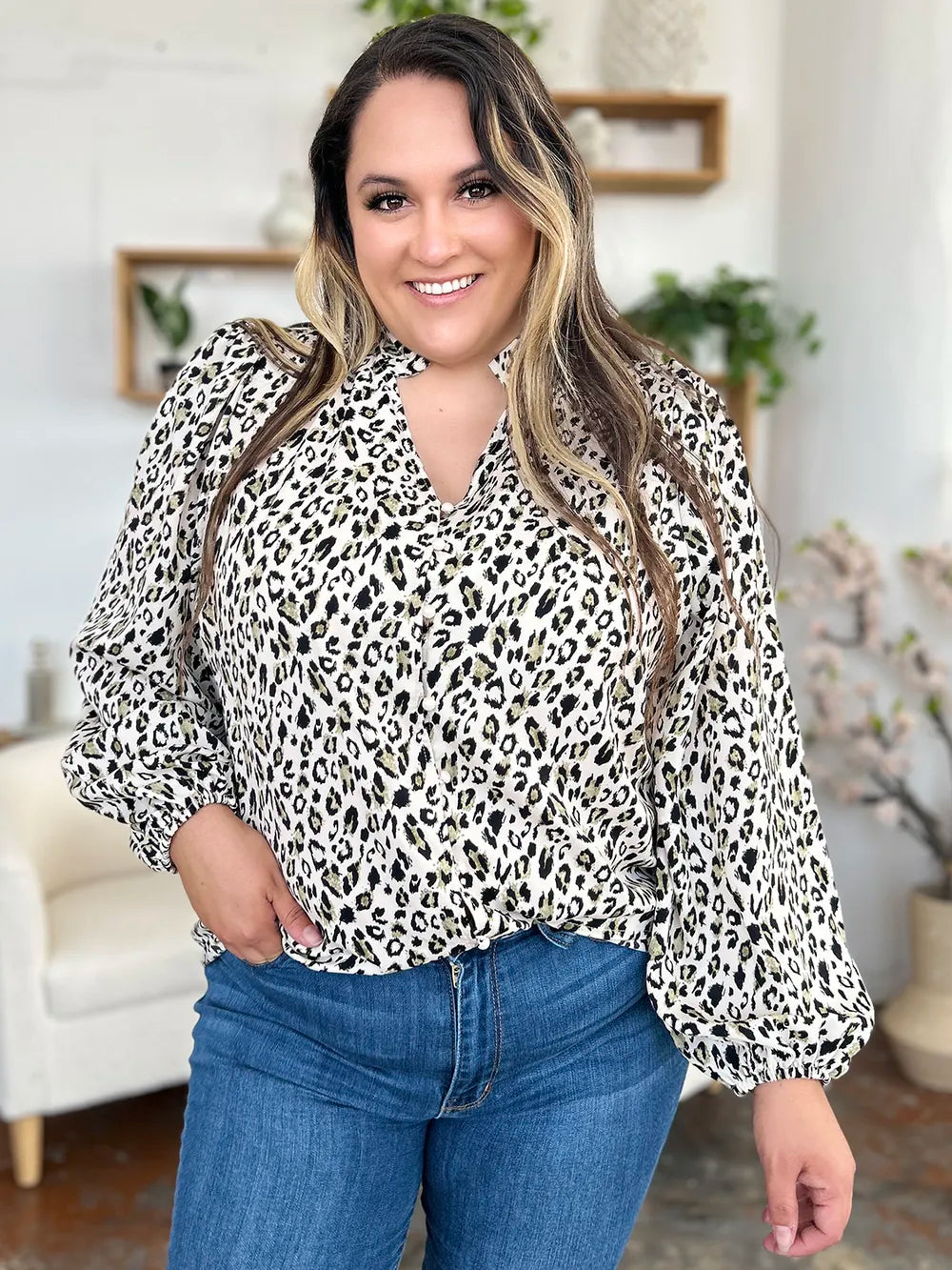 Plus size leopard print long sleeve blouse by Trendsi with a stylish, fitted design and vibrant animal print pattern.