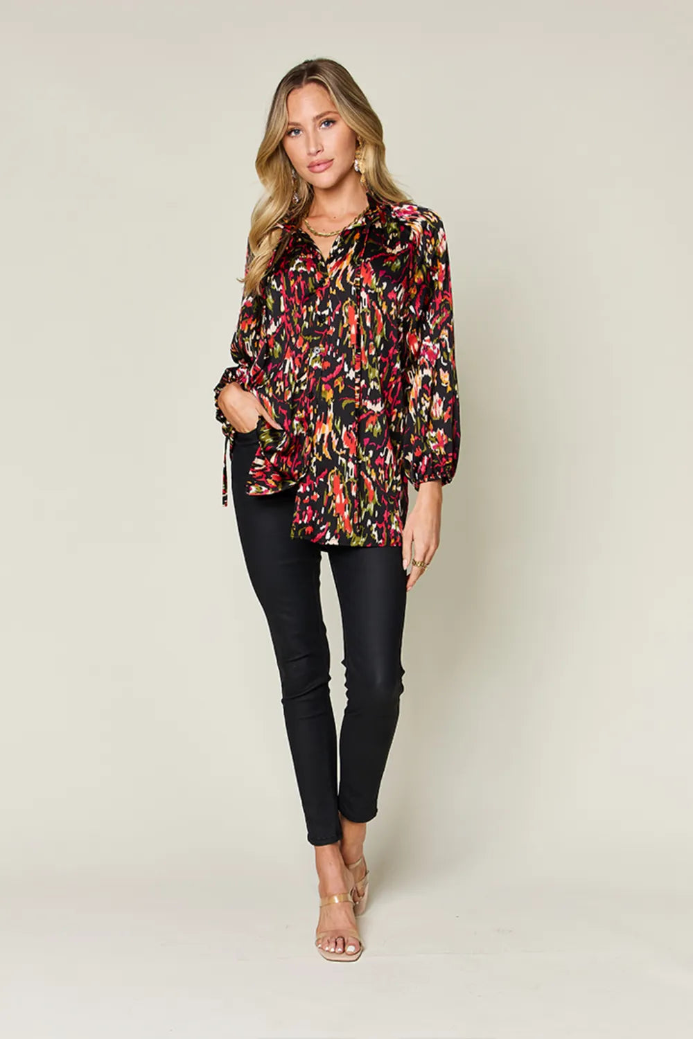 Plus size Trendsi Double Take printed button-up long sleeve shirt hanging on a wooden hanger.