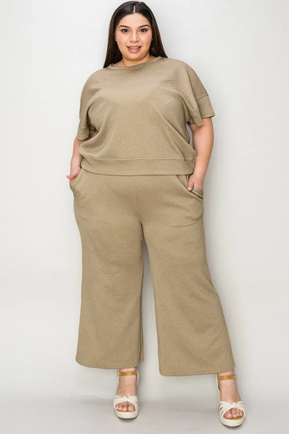 Trendsi double take full size texture short sleeve top and matching pants set, featuring a stylish, textured fabric in a coordinated outfit.