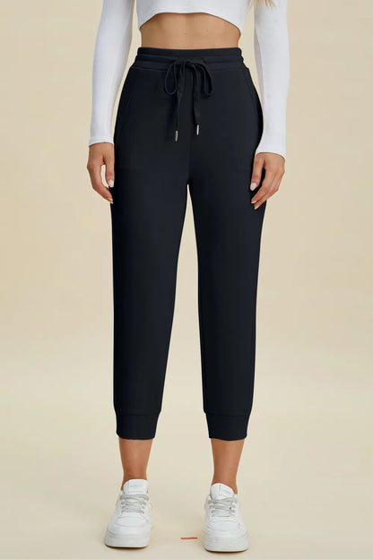 Trendsi Basic Bae full-size air scuba high-waist cropped pants with drawstring, shown in a relaxed fit on a model.
