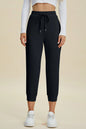 Trendsi Basic Bae full-size air scuba high-waist cropped pants with drawstring, shown in a relaxed fit on a model.