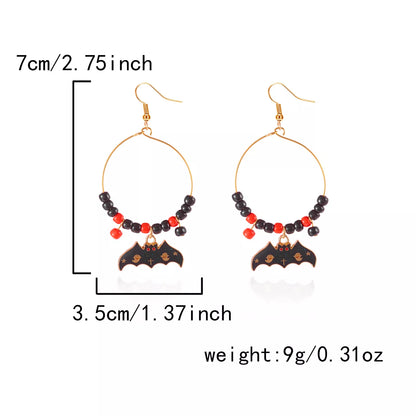 Halloween bat charm hoop earrings featuring black bat designs on silver hoops, perfect for spooky seasonal accessories.