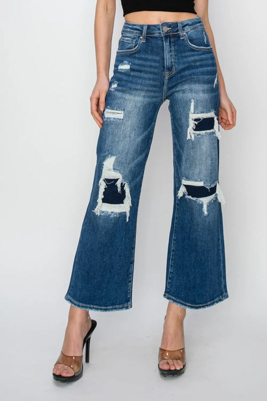 Risen high rise wide leg crop jeans with patch detailing, styled with a relaxed fit and trendy denim look.