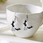 Halloween bat drop earrings by Trendsi featuring black bat-shaped dangle earrings for spooky seasonal style.