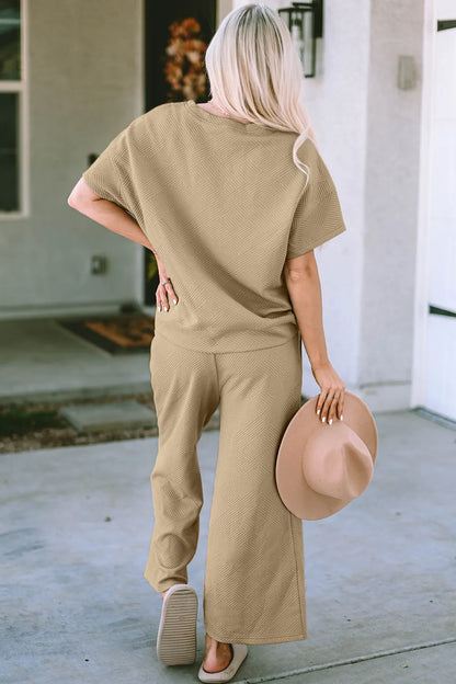 Trendsi Double Take full size textured short sleeve top and matching pants set, casual fashion ensemble with a comfortable fit.