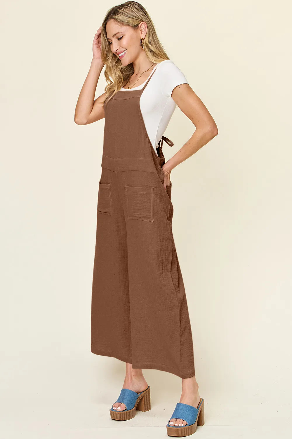 Trendsi double take full size textured sleeveless wide-leg overall displayed on a hanger with a neutral background.