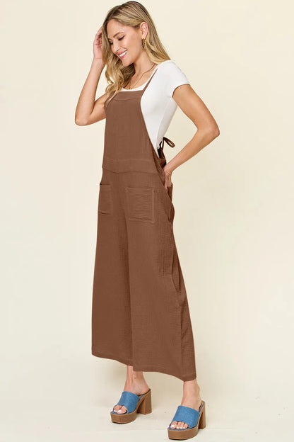 Trendsi double take full size textured sleeveless wide-leg overall displayed on a hanger with a neutral background.
