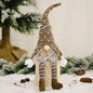 Faceless gnome figurine with long legs and light-up feature, designed by Trendsi, standing on a neutral surface.
