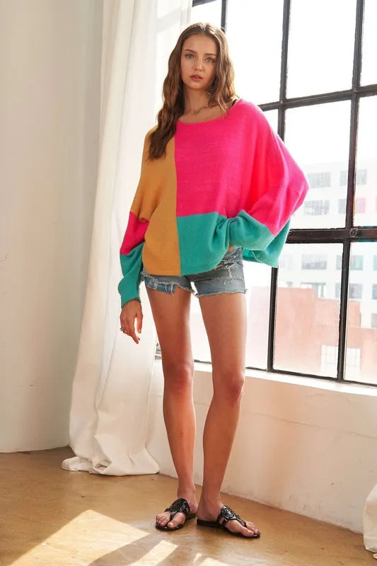 ADORA loose fit colorblock sweater by Trendsi featuring a cozy, casual design with vibrant color blocking on soft knit fabric.