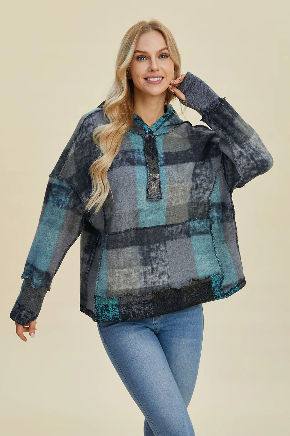 Plus size plaid fleece hoodie with dropped shoulders from Trendsi, featuring a cozy, casual design and full front coverage.
