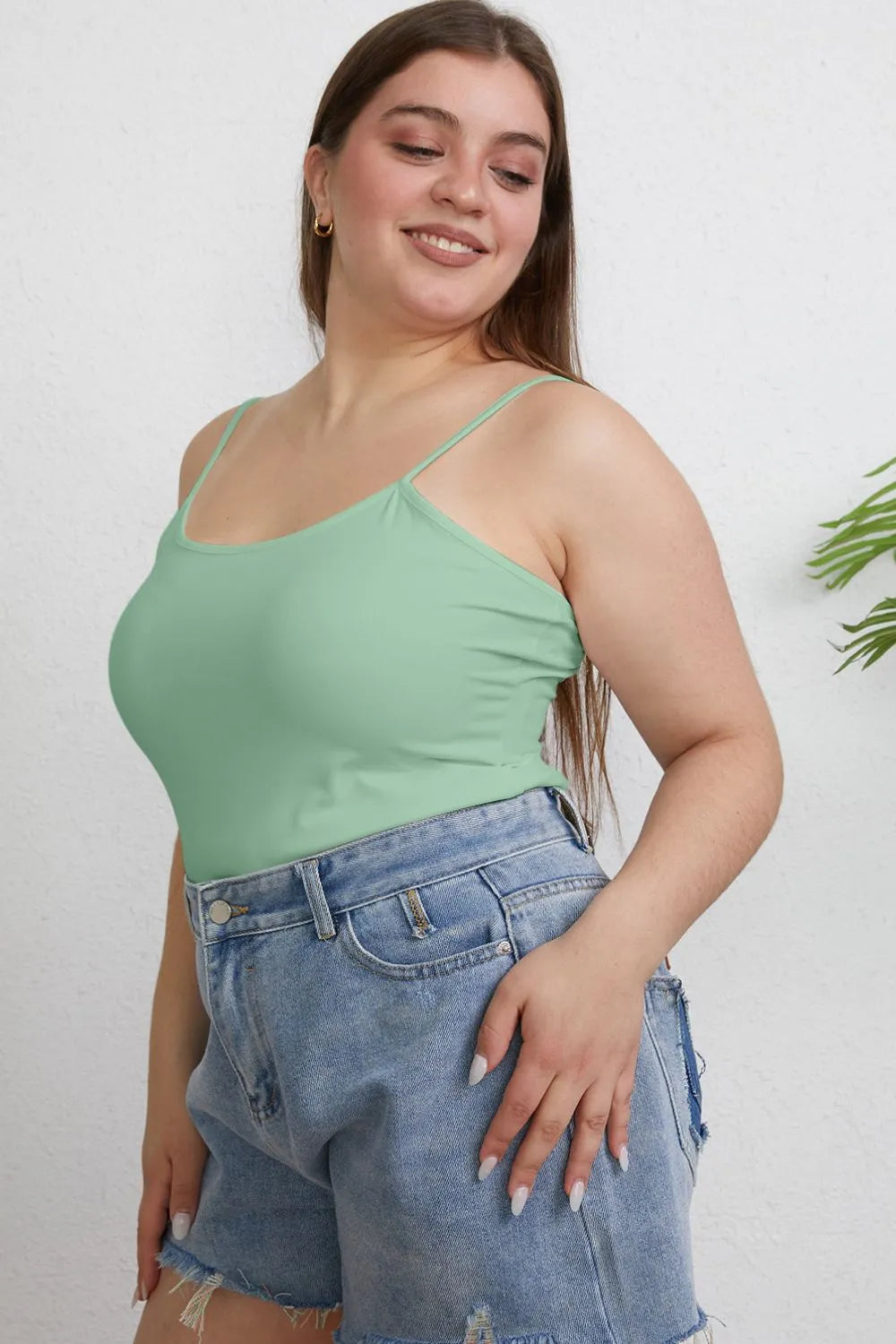 Plus size Basic Bae full size round neck slim cami by Trendsi, showing a close-up of the fitted, sleeveless camisole in soft fabric.