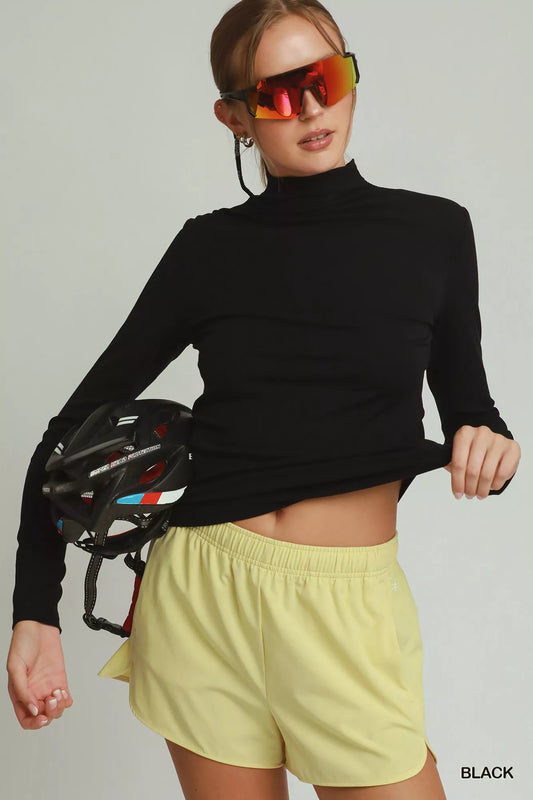 Trendsi Umgee long sleeve mock neck top in soft fabric, featuring a fitted silhouette and classic design for casual wear.