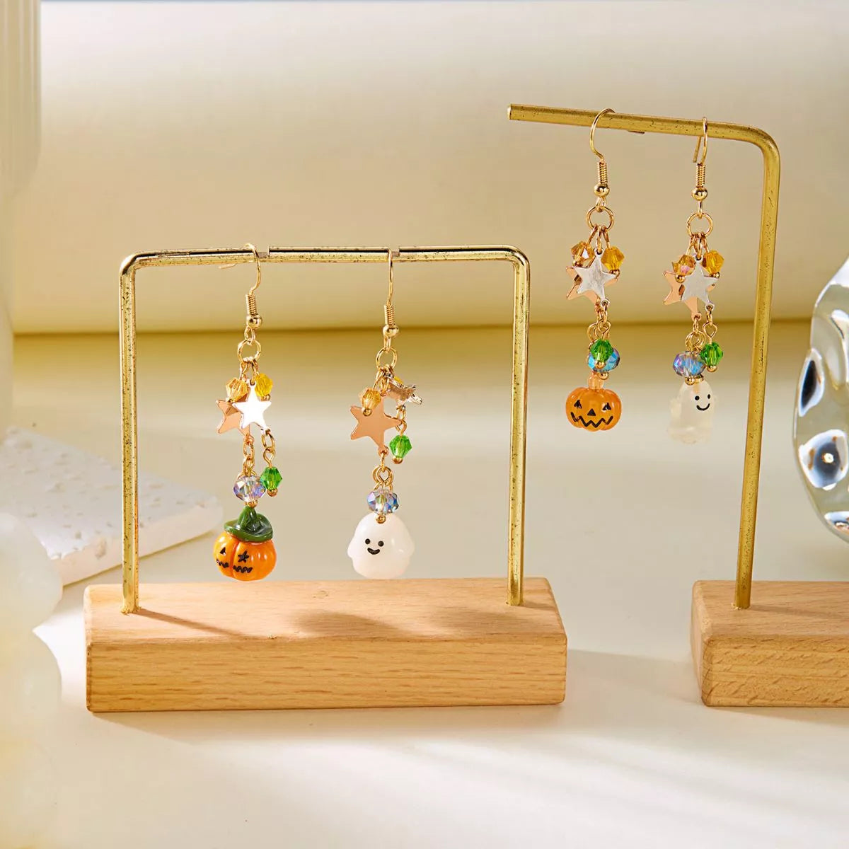 Halloween asymmetrical pumpkin and ghost earrings by Trendsi featuring spooky, festive metal earrings with pumpkin and ghost charms.