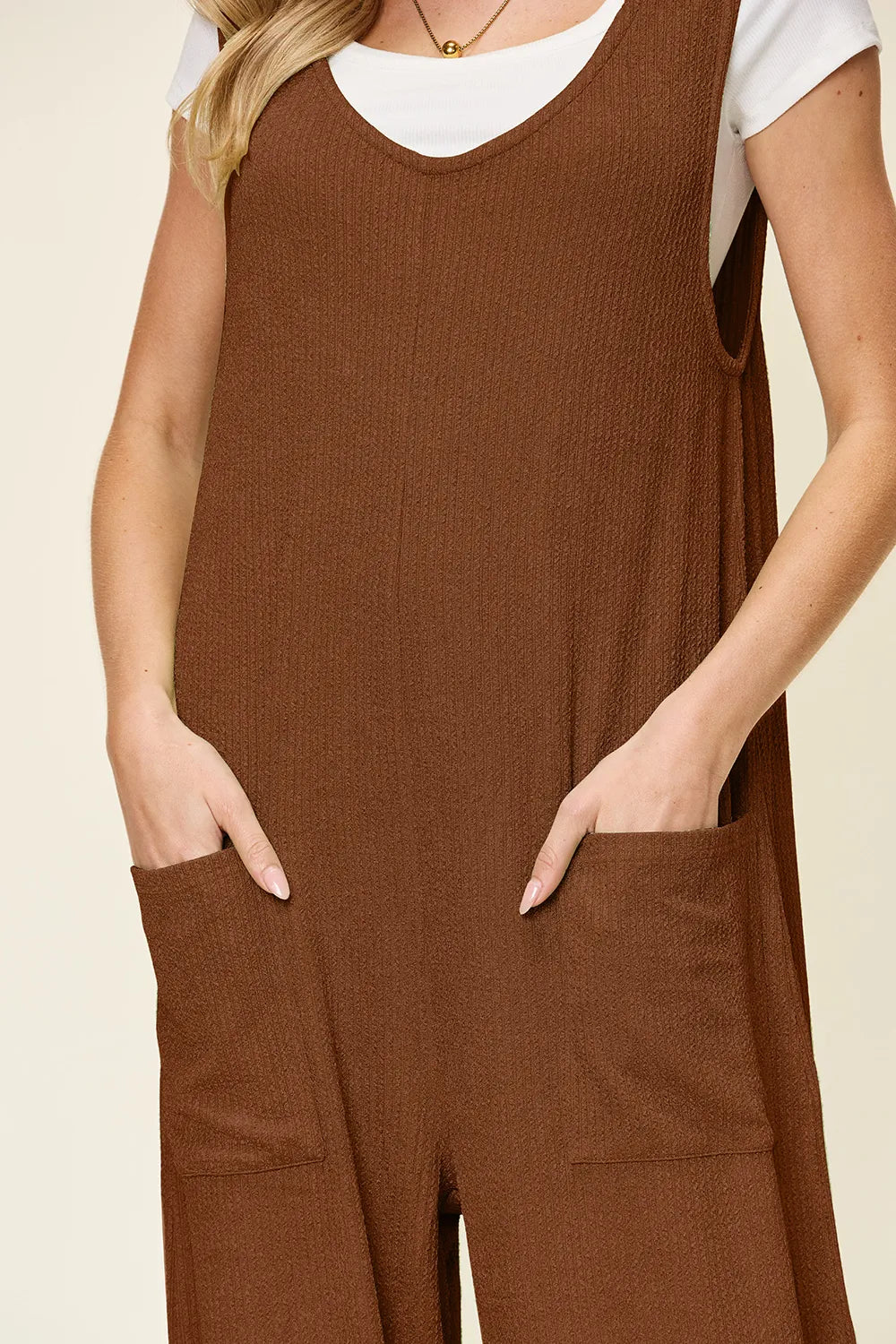 Trendsi double take full size textured sleeveless wide-leg jumpsuit displayed on a mannequin, showing its stylish fit and fabric details.