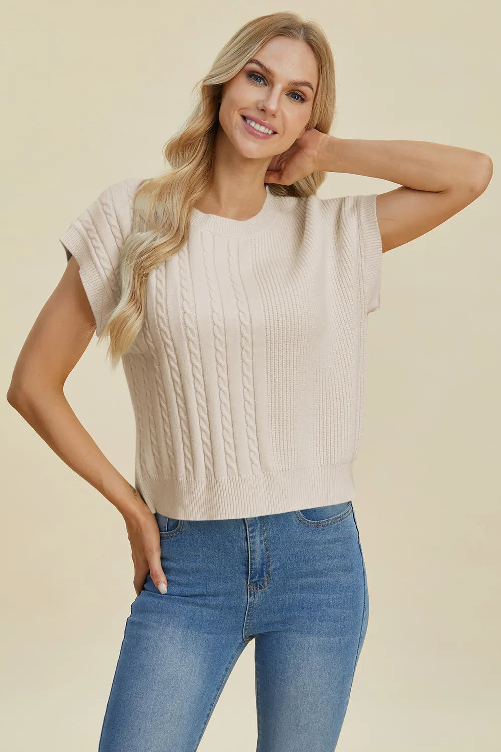 Plus size cable-knit round neck short sleeve sweater by Trendsi, showcasing a cozy, full-size cable knit design and classic fit.