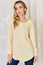Basic Bae full-size ribbed round neck slit T-shirt by Trendsi, featuring a ribbed fabric and a stylish slit detail.