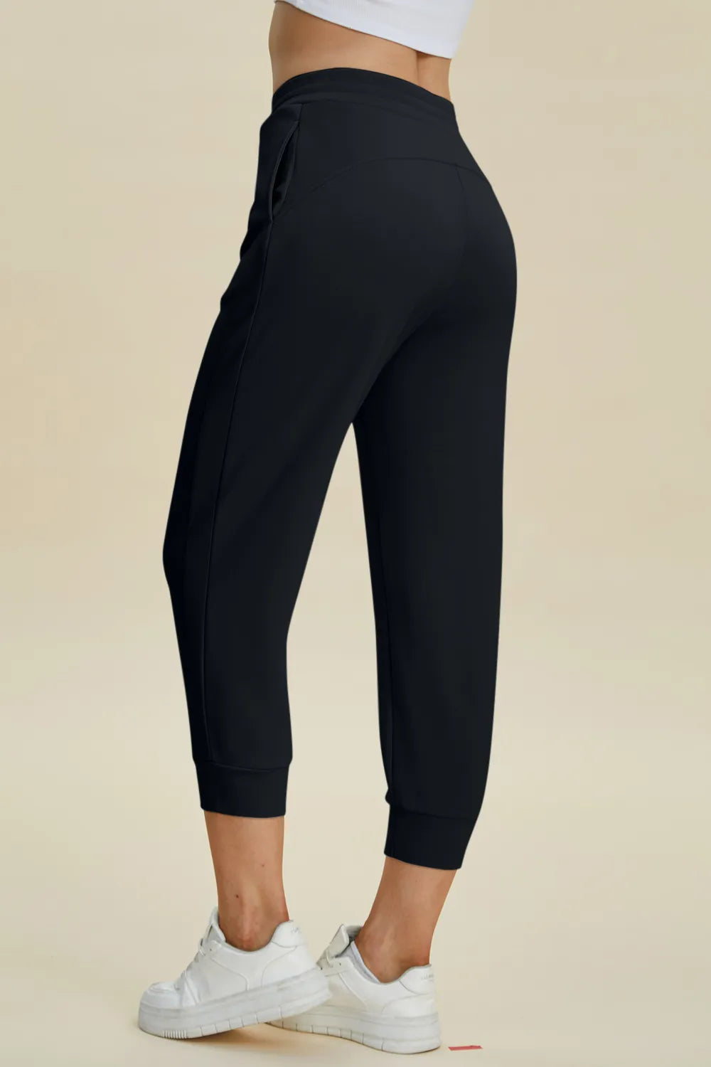 Trendsi Basic Bae high waist air scuba drawstring cropped pants in black, showcasing the relaxed fit and stretchy fabric.