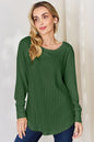 Basic Bae full size ribbed round neck slit T-shirt by Trendsi, shown in black with ribbed fabric and a relaxed fit.
