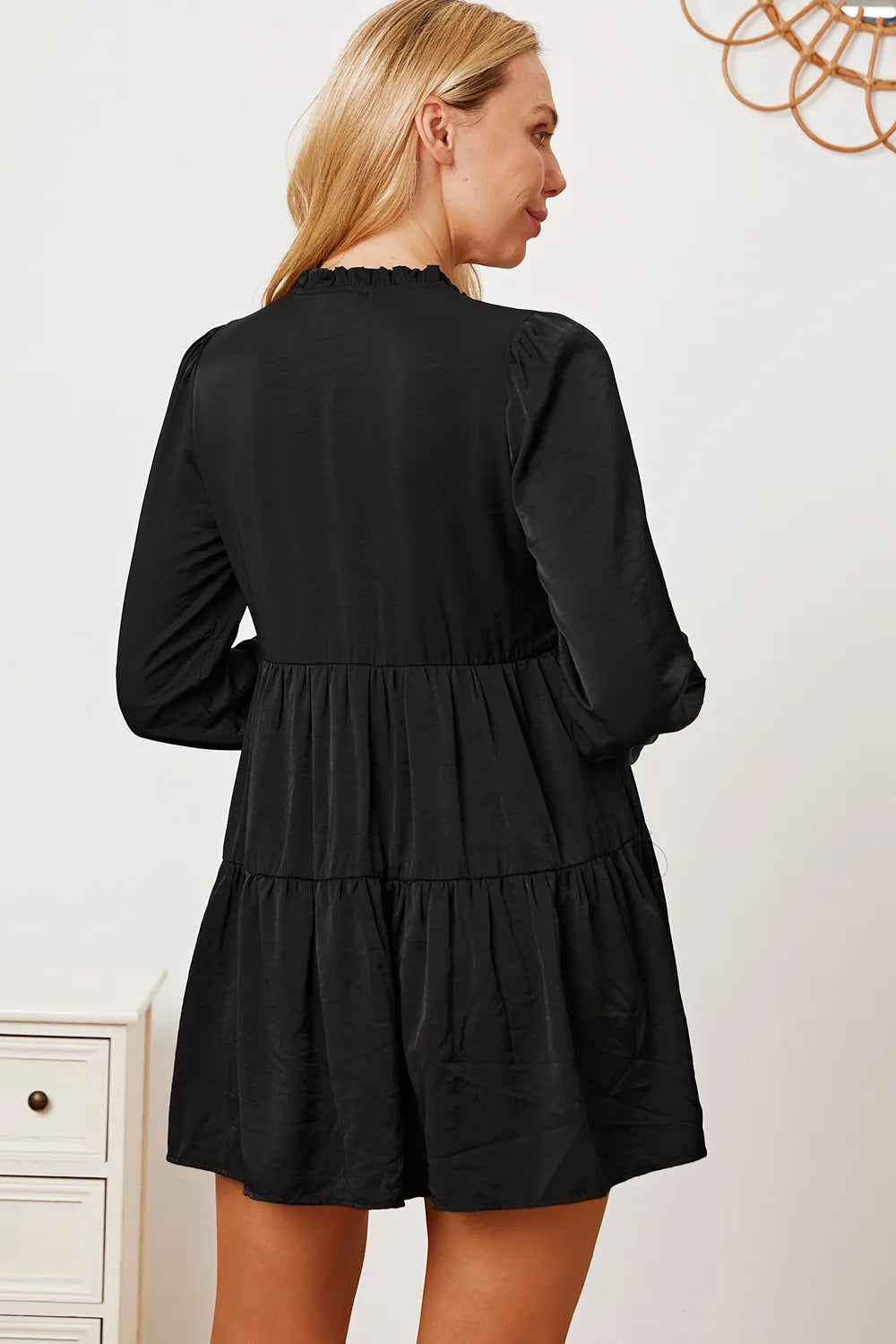 Ruffled button-up long sleeve tiered shirt by Trendsi, featuring layered fabric and detailed ruffle accents in a stylish design.