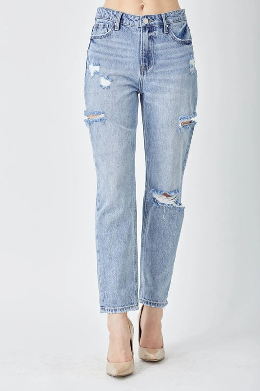 Distressed slim cropped jeans by Trendsi featuring a distressed finish, slim fit, and cropped length, shown on a person.