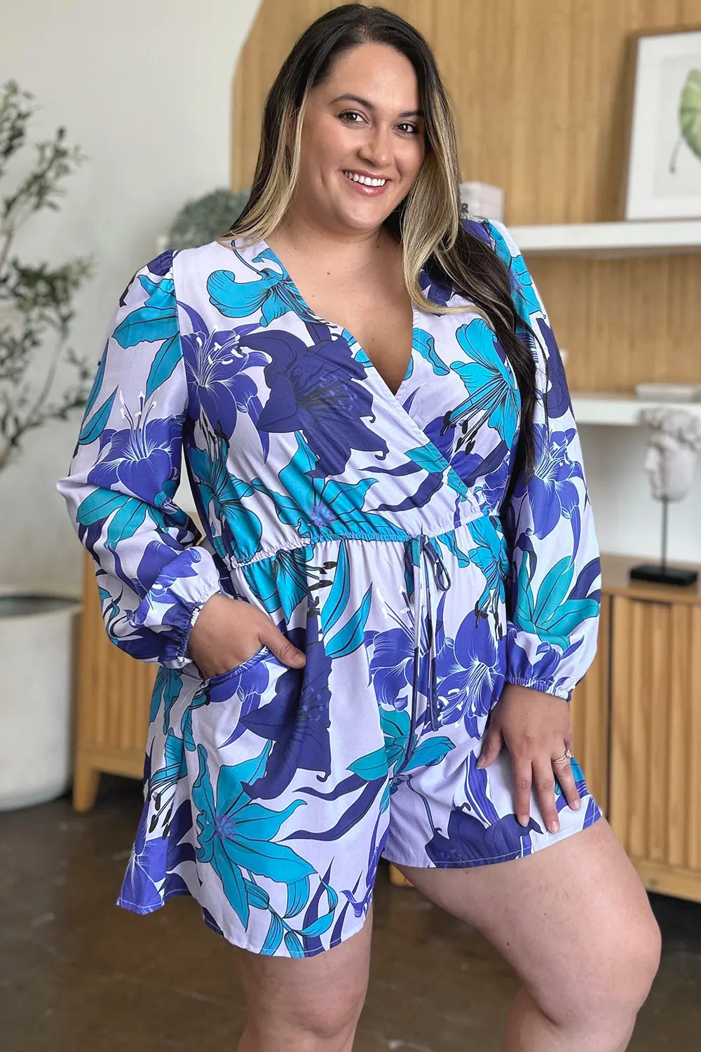 Trendsi Double Take floral long sleeve romper with pockets, full size, featuring a vibrant floral pattern and comfortable fit.