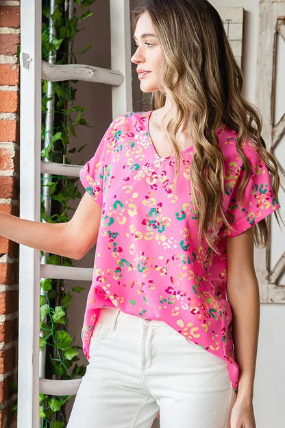 Heimish full size animal print V-neck short sleeve T-shirt in plus size, featuring a bold animal pattern and comfortable fit.