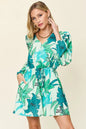 Trendsi Double Take floral long sleeve romper with pockets, featuring a full size, vibrant floral print and comfortable fit.