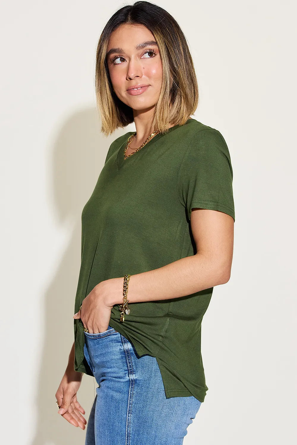 Basic Bae full size V-neck high-low T-shirt by Trendsi, shown in black with a relaxed fit and stylish V-neck design.