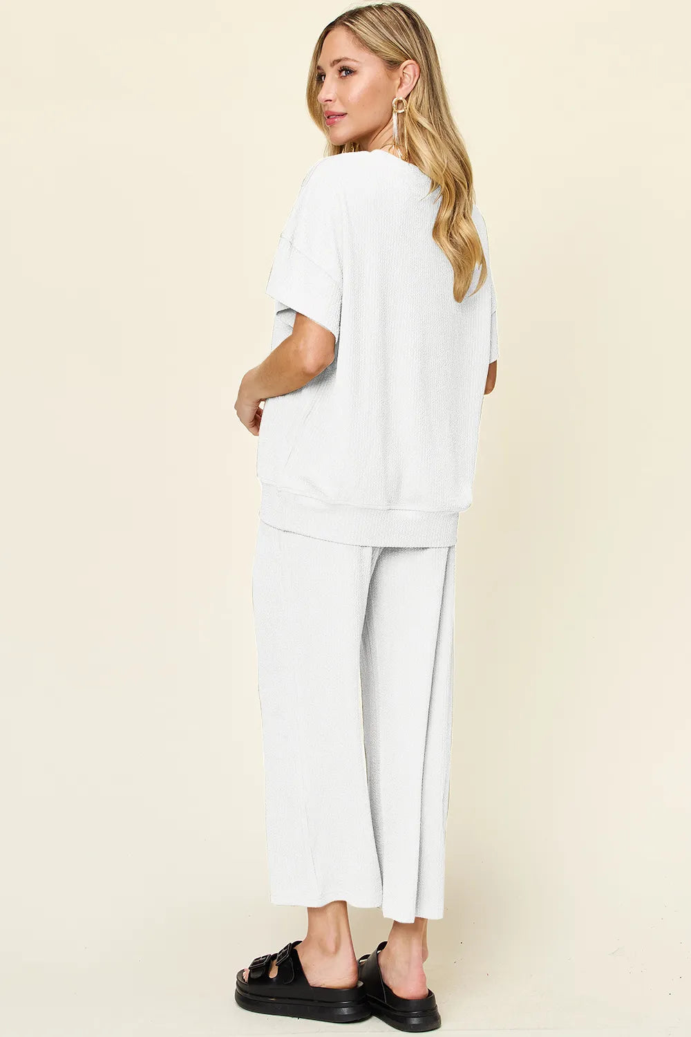 Trendsi double take full size textured round neck short sleeve t-shirt paired with wide-leg pants, casual and comfortable outfit.