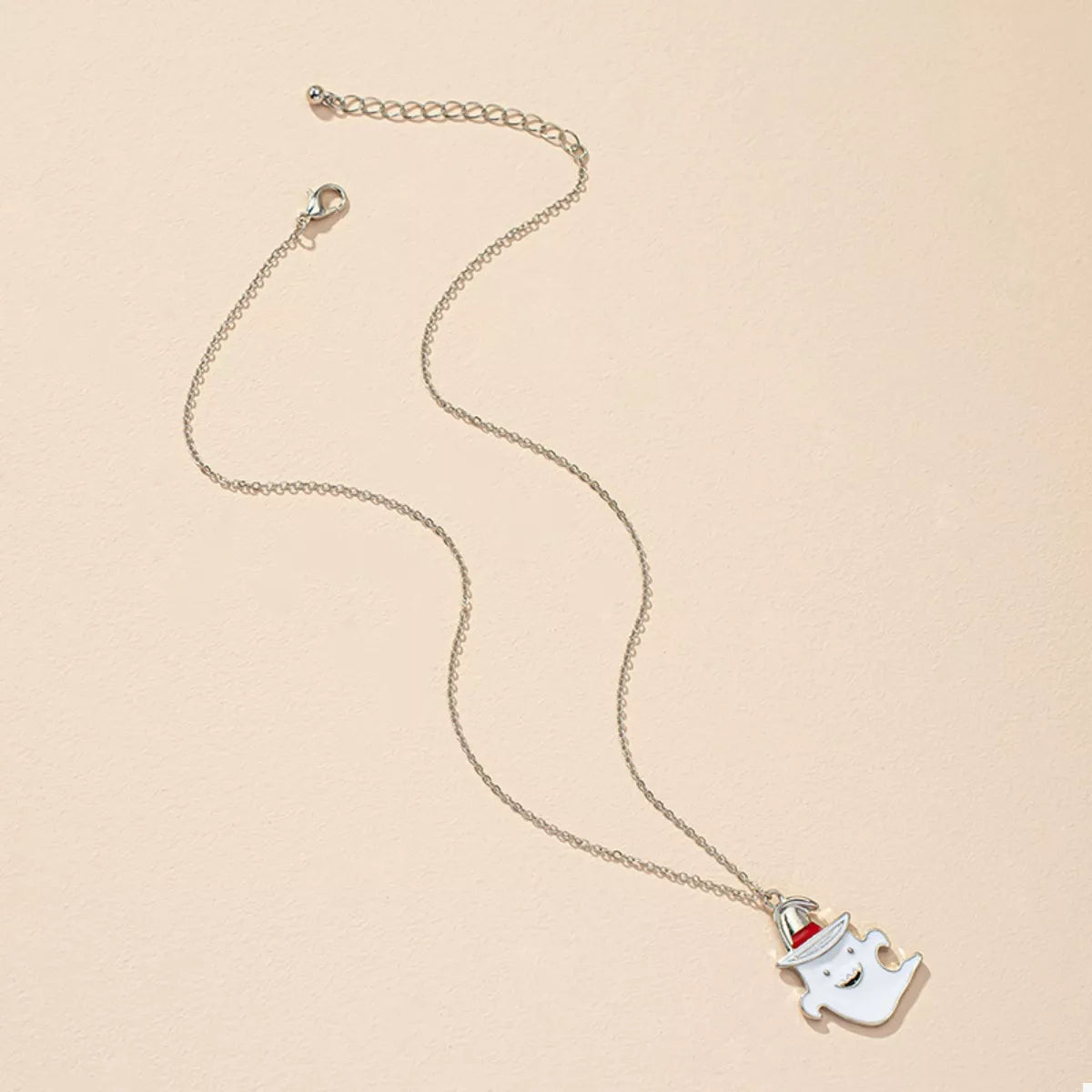 Cute Halloween ghost pendant necklace from Trendsi featuring a whimsical ghost charm on a silver chain.