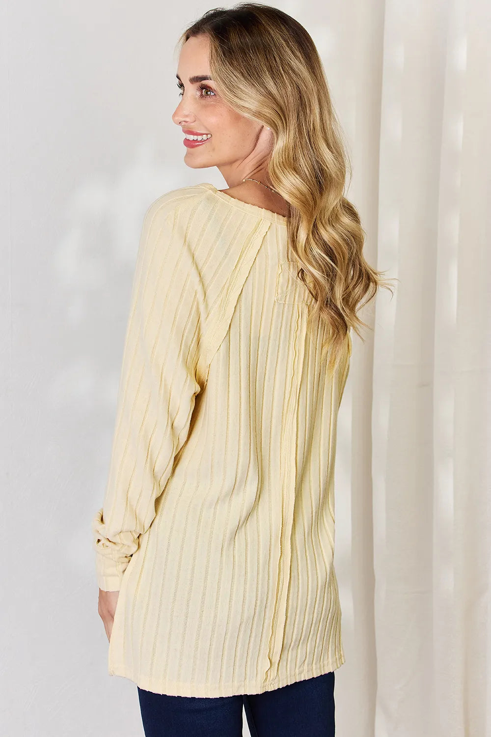 Basic Bae full size ribbed round neck slit T-shirt by Trendsi, featuring a ribbed fabric and stylish slit detail.