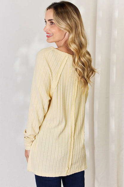Basic Bae full size ribbed round neck slit T-shirt by Trendsi, featuring a ribbed fabric and stylish slit detail.