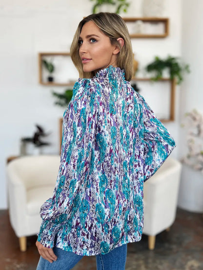 Printed smocked long sleeve blouse from Trendsi featuring a stylish design and full-length sleeves, perfect for casual or dressy occasions.