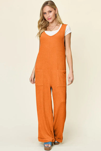 Full view of Trendsi Double Take full size sleeveless texture wide leg jumpsuit, featuring a fitted bodice and flowing wide-leg pants.