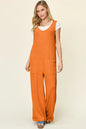 Full view of Trendsi Double Take full size sleeveless texture wide leg jumpsuit, featuring a fitted bodice and flowing wide-leg pants.