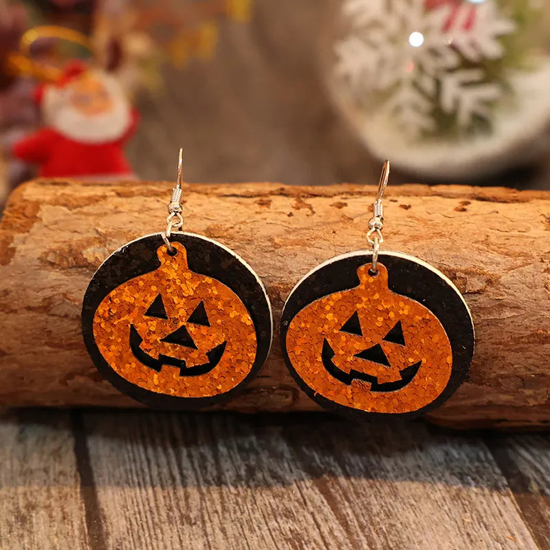 PU leather pumpkin earrings by Trendsi featuring orange pumpkin-shaped dangles perfect for fall accessories.