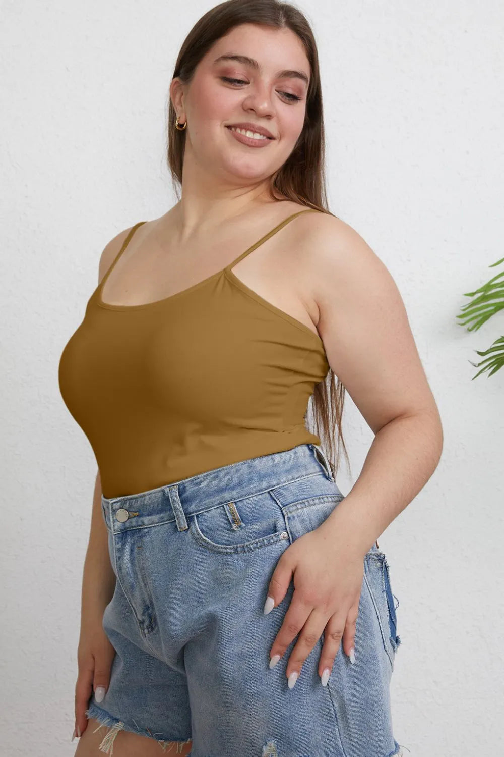 Plus size basic Bae full size round neck slim cami by Trendsi, featuring a close-up of the black sleeveless top with a round neckline.